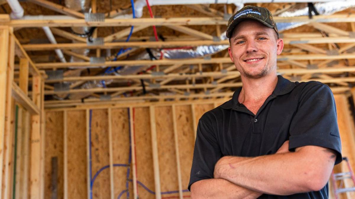 image of man posing with arms crossed.