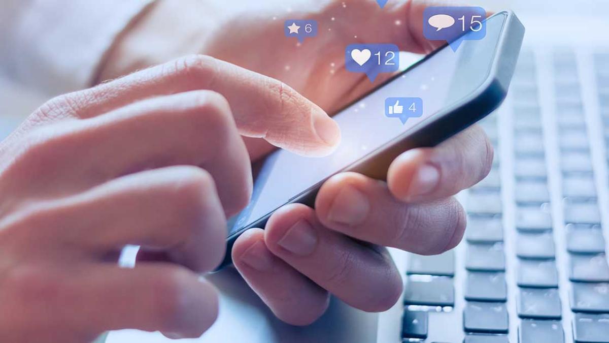 Close-up image of hands holding a smart phone.