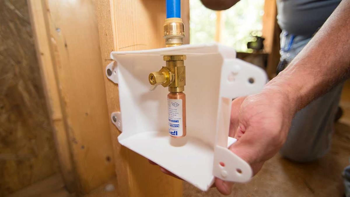 Close up of a Outlet box with hammer arrestor being installed
