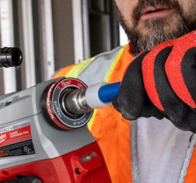Poly expansion fitting being installed on PEX-A pipe with expansion tool