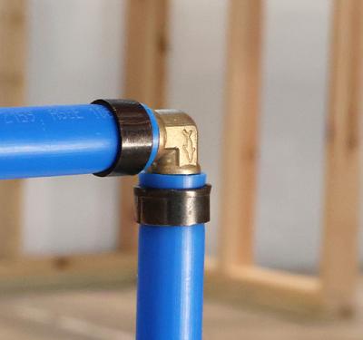 A SharkBite PEX Crimp Brass Fitting Installed