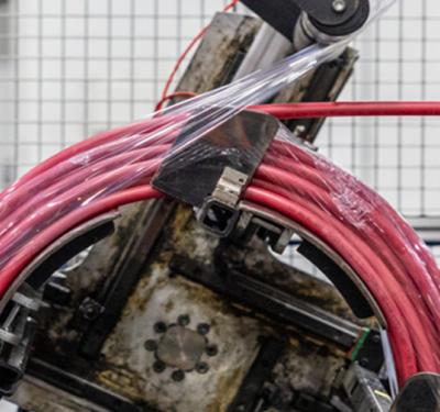 A coil of SharkBite PEX being packaged