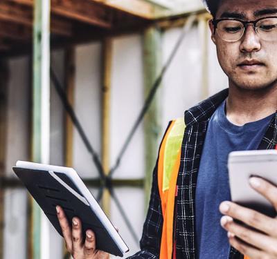 A contractor on the job site using a mobile device to download specs.