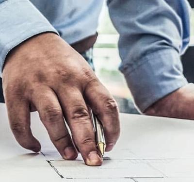 Contractors reviewing plumbing specifications on a job site, highlighting planning and precision in professional construction projects.