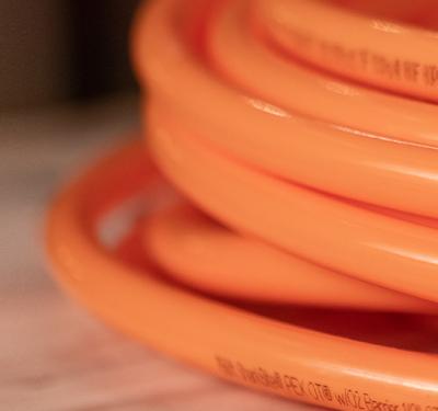 SharkBite oxygen barrier PEX tubing coil designed specifically for radiant floor and hydronic heating systems, preventing oxygen permeation for enhanced system longevity