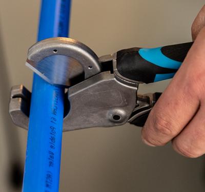 Professional SharkBite PEX installation tools featuring precision pipe cutters and the essential PEX crimp tool for secure, leak-free connections in plumbing installations