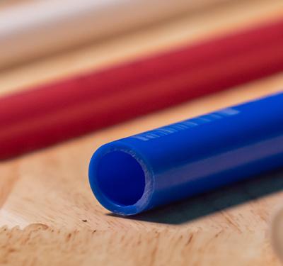 Different colors of SharkBite PEX pipe on a table