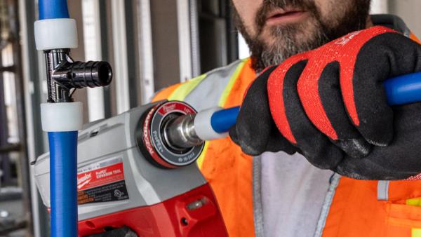 Poly expansion fitting being installed on PEX-A pipe with expansion tool