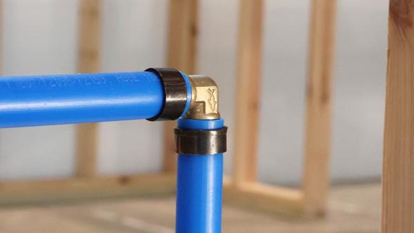 A SharkBite PEX Crimp Brass Fitting Installed