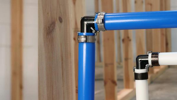A SharkBite poly crimp/clamp fitting installed