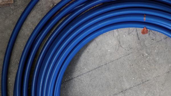 Coiled SharkBite PEX-A potable water tubing with superior flexibility and durability for residential and commercial plumbing applications
