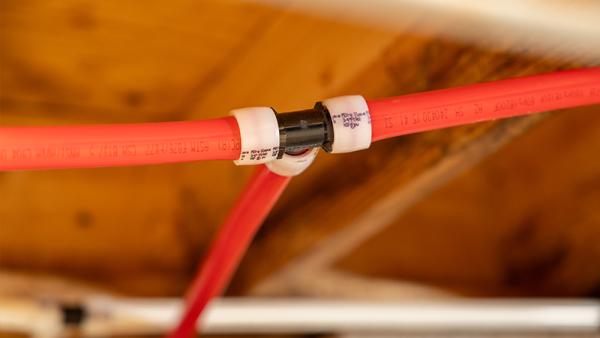 Red SharkBite PEX pipe and expansion fitting