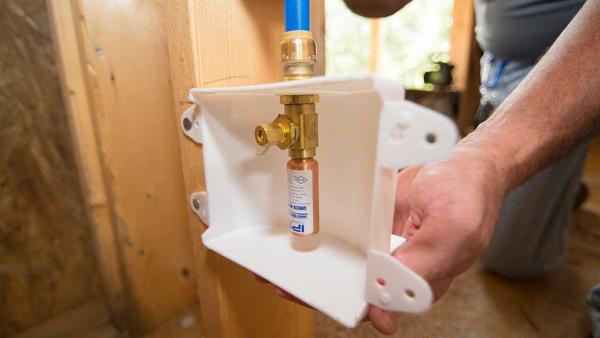 Close up of a Outlet box with hammer arrestor being installed