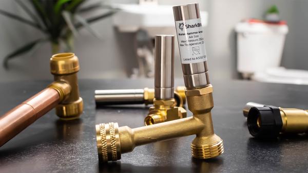 SharkBite water hammer arrestors with pressure-absorbing chambers to protect plumbing systems from water hammer damage and noise