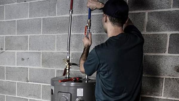A person fixing a water heater