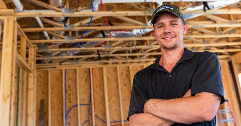 image of man posing with arms crossed.