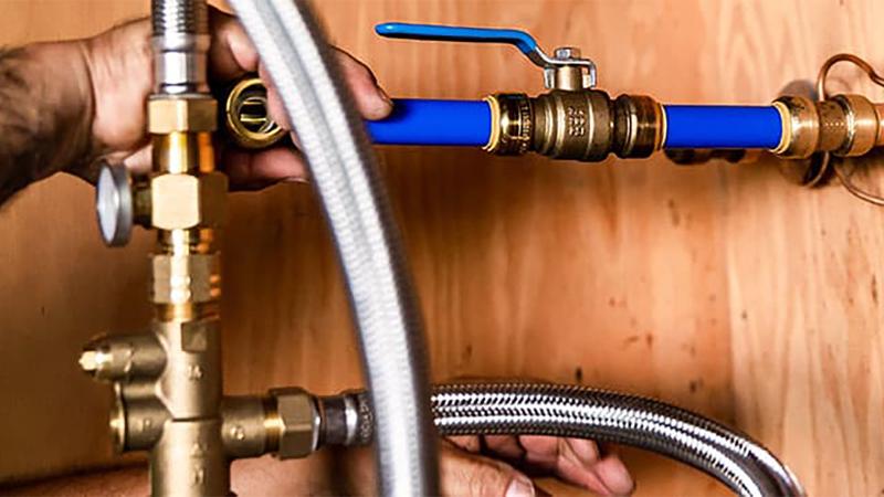 RWC product expert showcasing the benefits of Cash Acme valves in a plumbing demonstration, emphasizing innovation and water control solutions.