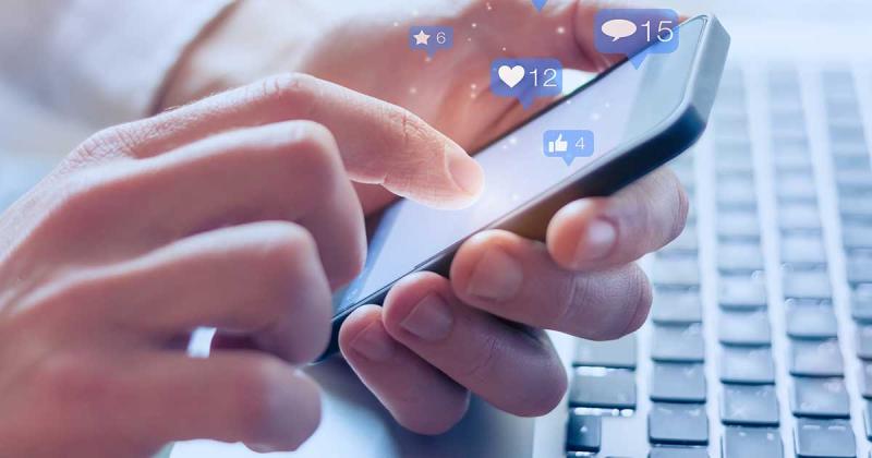 Close-up image of hands holding a smart phone.
