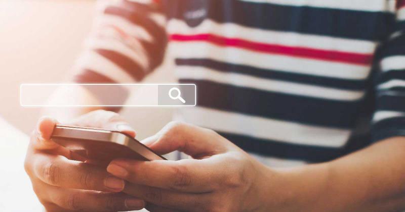 Image of a person on their mobile phone.