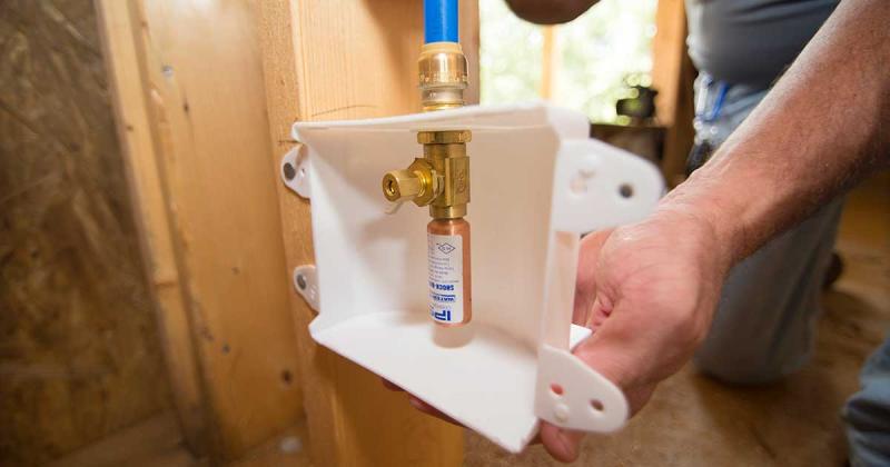 Close up of a Outlet box with hammer arrestor being installed