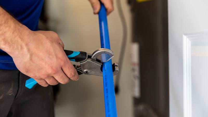plumber using pipe cutters 