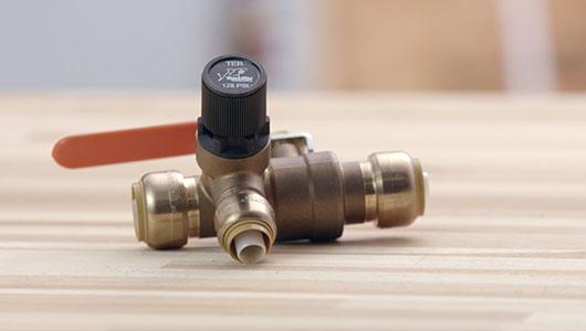 close up of a thermal expansion relief valve laying on a table.